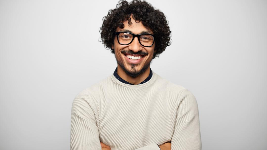 Man in white business attire smiling