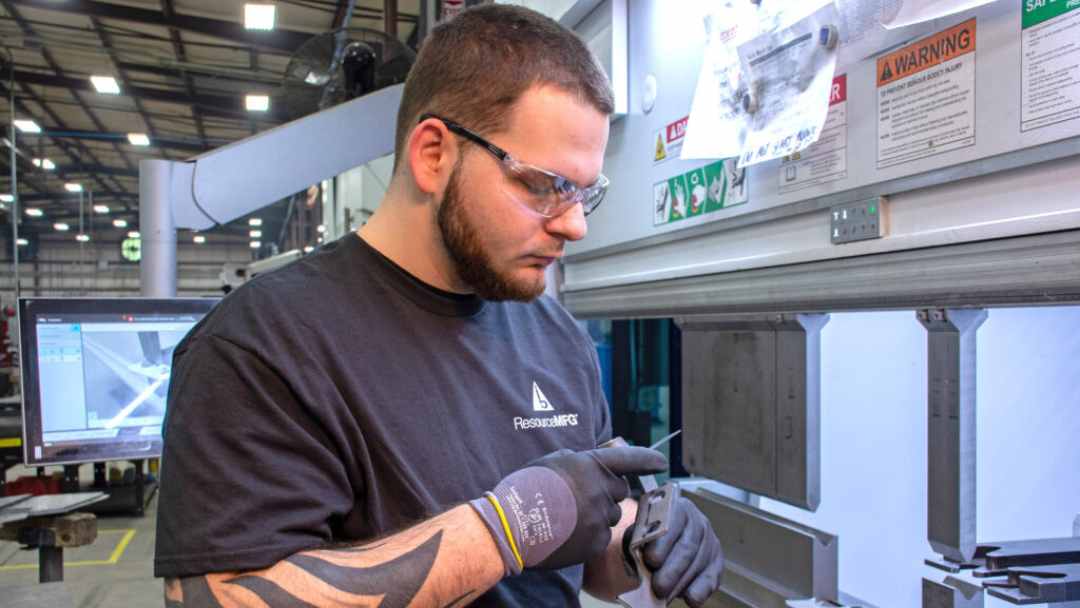 Man doing manual quality checks of manufacturing product 