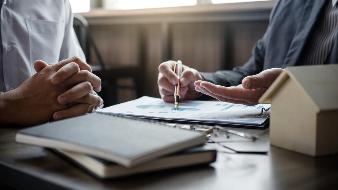 two people reviewing paperwork at a desk