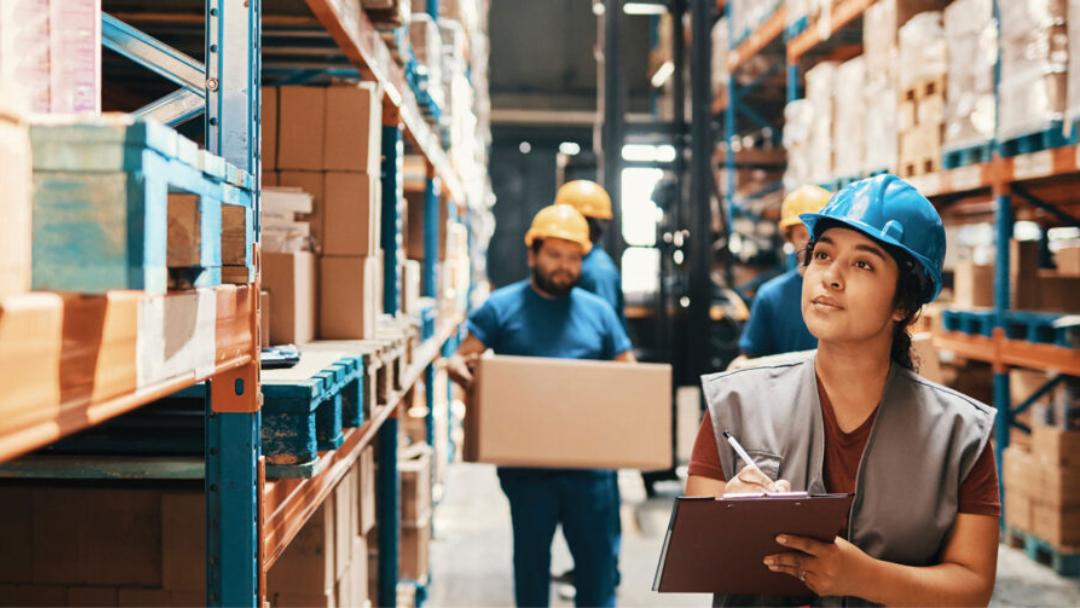 warehouse team walking down a warehouse aisle 