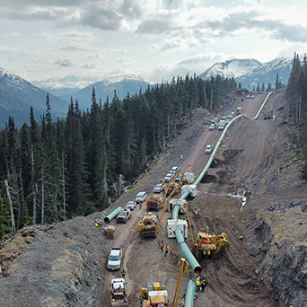 birds eye view of pipeline crew working with trucks and machinery 