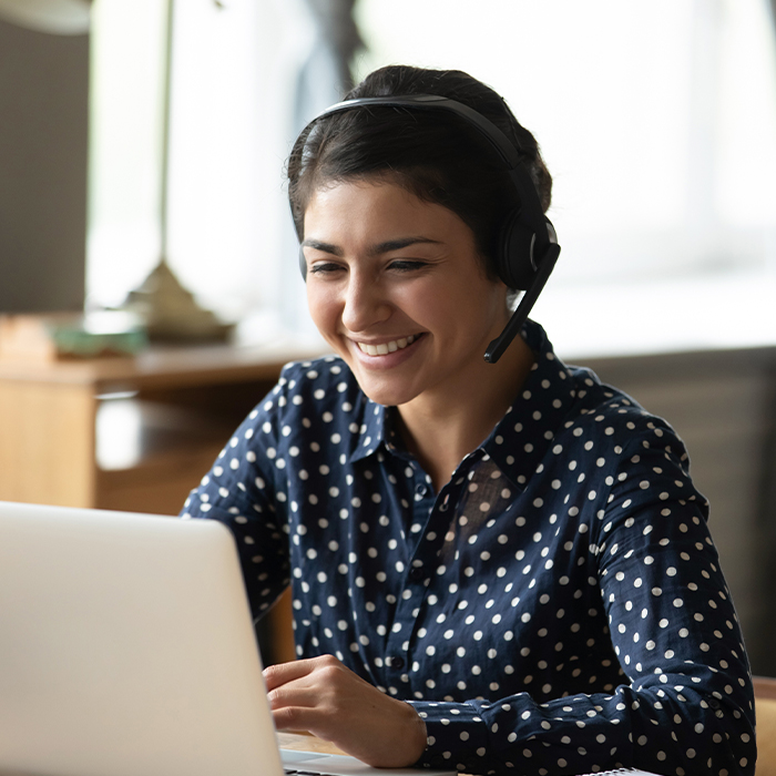 woman wearing a headset working on a computer