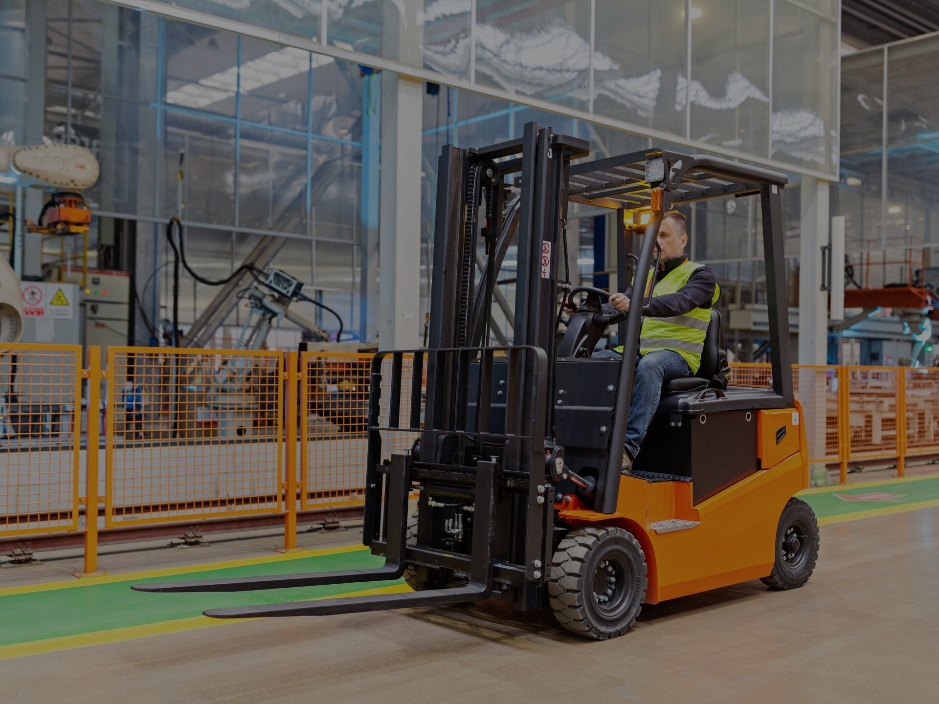 Forklift operator using a orange forklift machine.