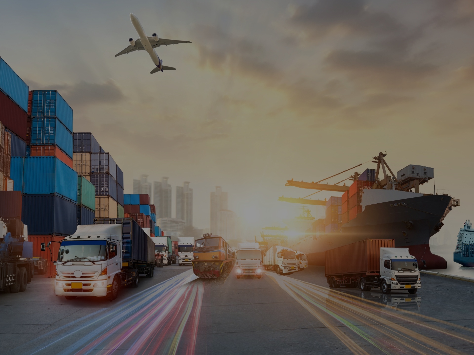 Multiple transportation and shipping vessels lined up next to each other.